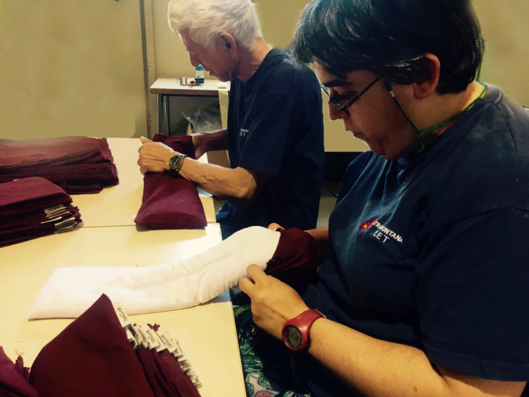 Maria, one of our workers putting covers on the pillows